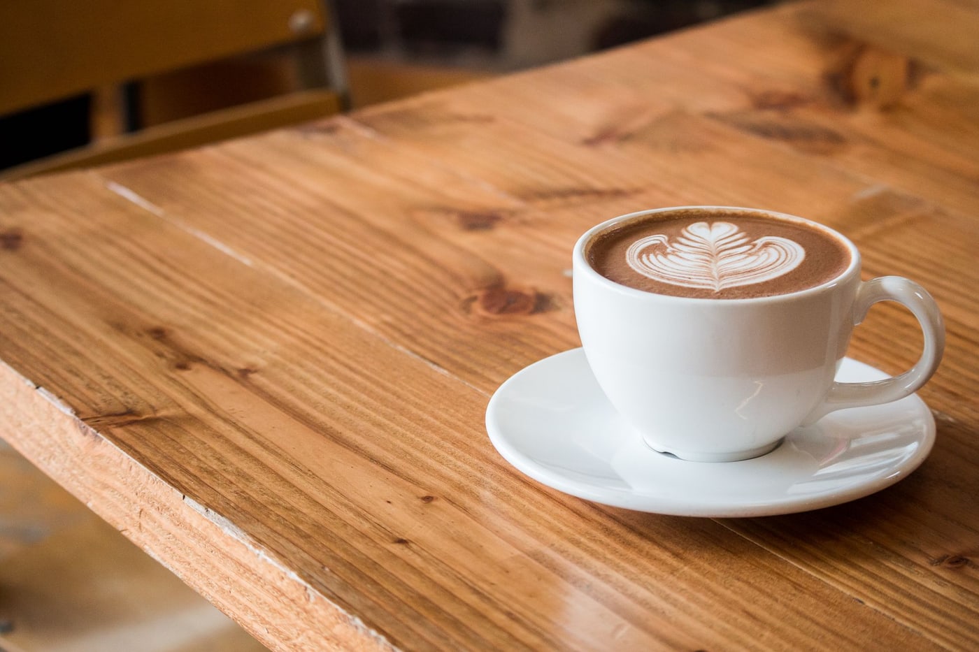 A warm cup of coffee with leaf-shaped latte art